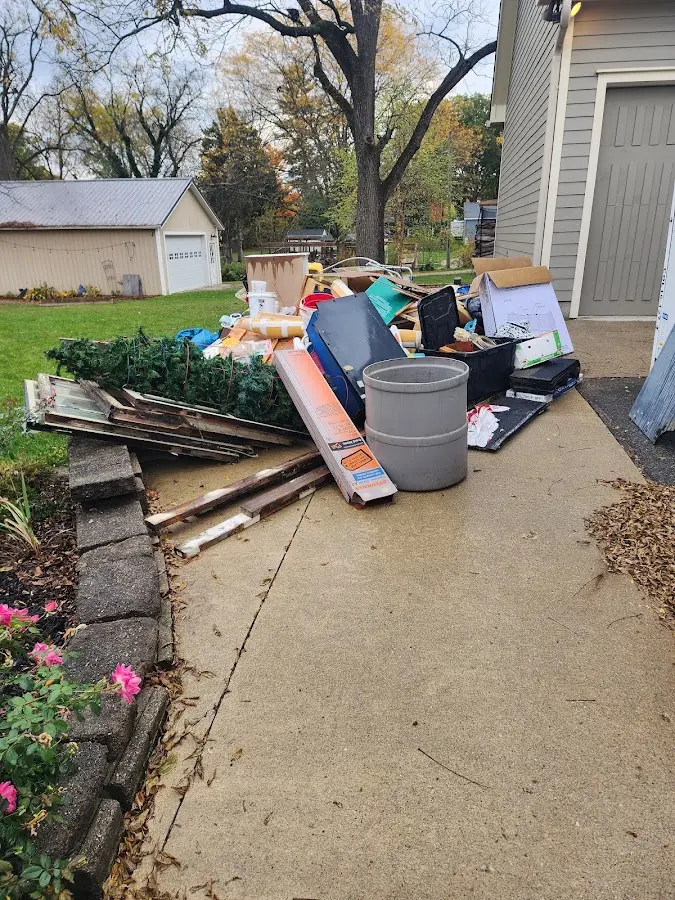 Dumpster being loaded with debris for 12 Yard Dumpster Rental in Findlay